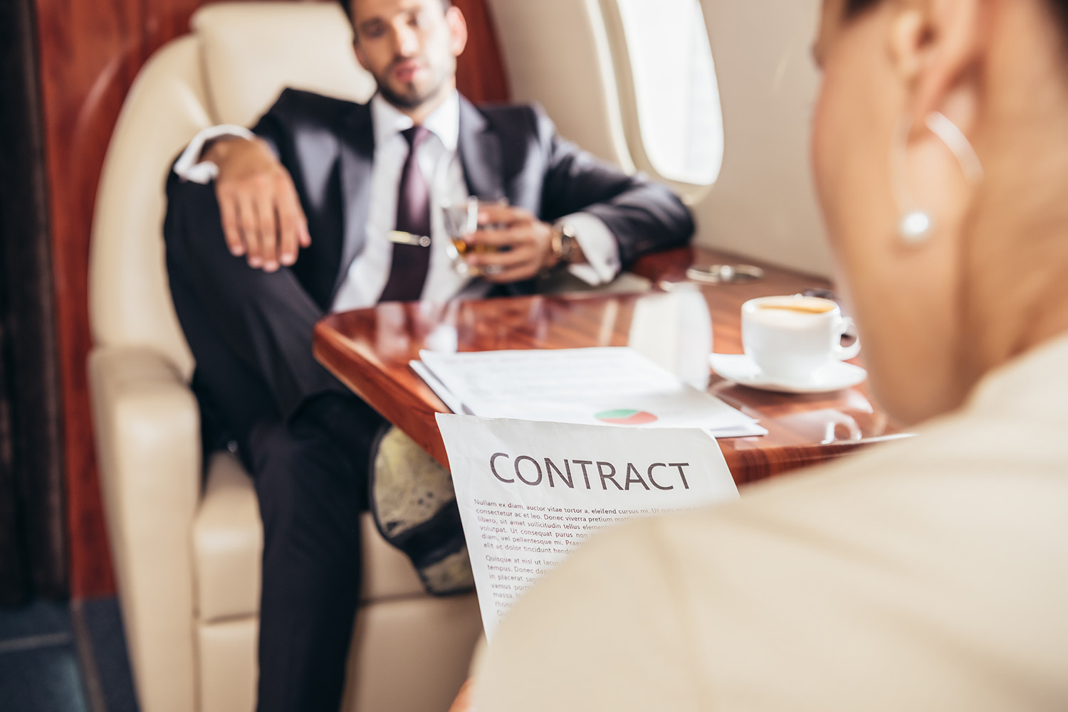 selective focus of businesswoman reading contract in private pla